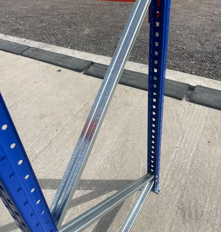 Galvanised bracing between two blue pallet racking uprights.